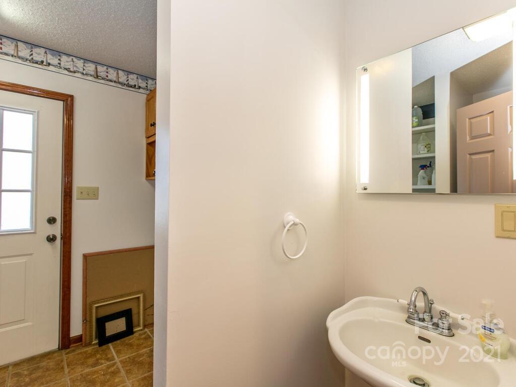 20 Brooks Branch Road Leicester, NC 28748 - Photo 25 of 40 a bathroom with a sink and mirror