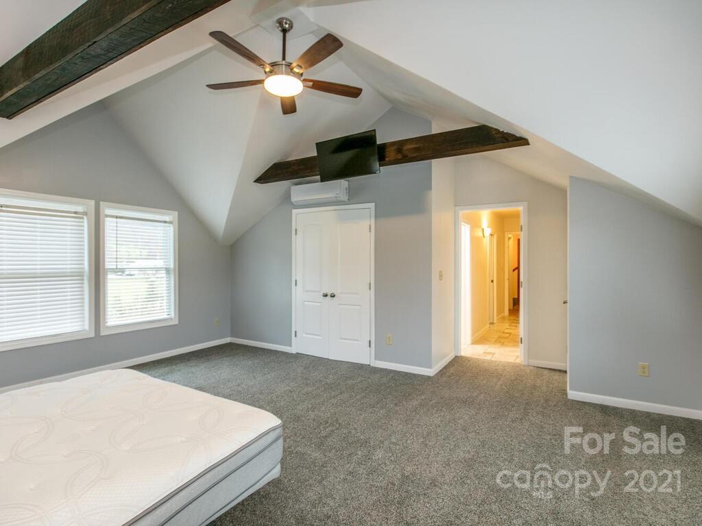 20 Brooks Branch Road Leicester, NC 28748 - Photo 31 of 40 a bedroom with a bed and a ceiling fan