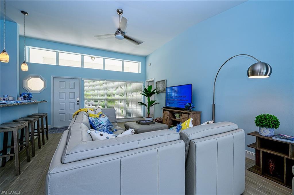7311 Mill Pond Circle Naples, FL 34109 - Photo 12 of 42 a living room with furniture and flat screen tv