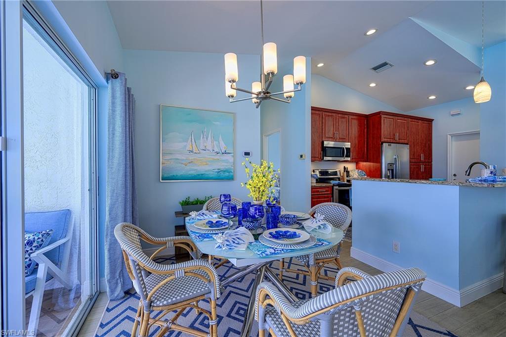 7311 Mill Pond Circle Naples, FL 34109 - Photo 15 of 42 a view of a dining room with furniture