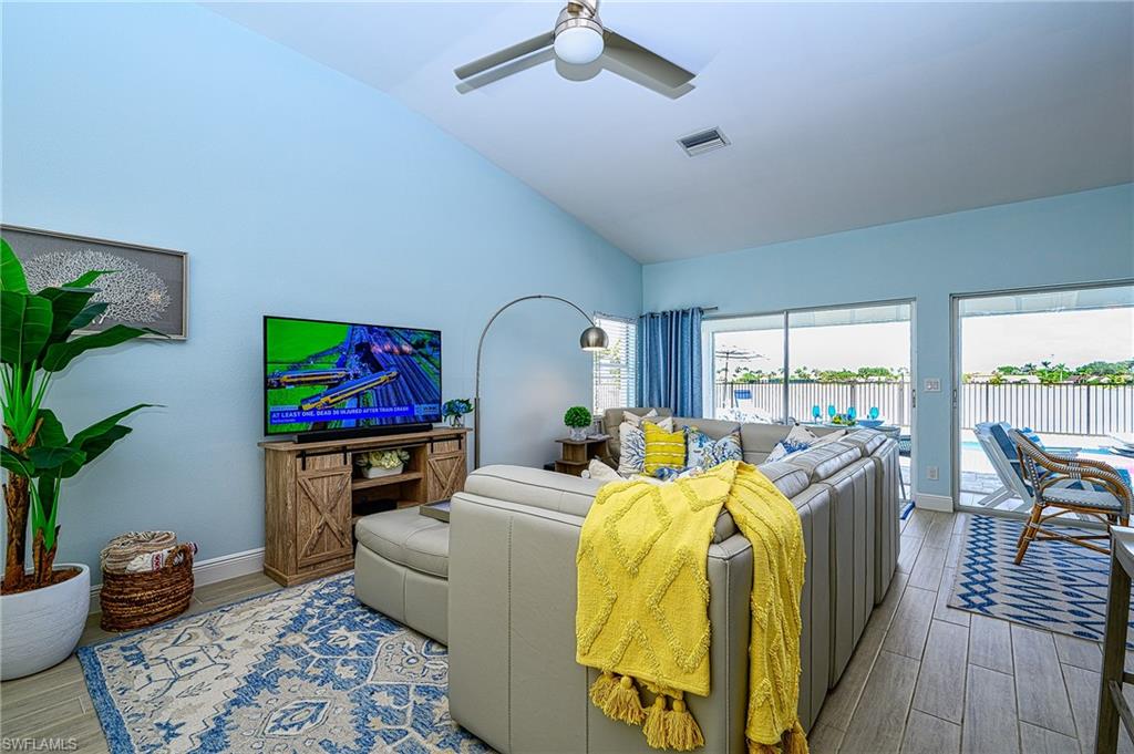 7311 Mill Pond Circle Naples, FL 34109 - Photo 17 of 42 a bedroom with furniture and a fireplace