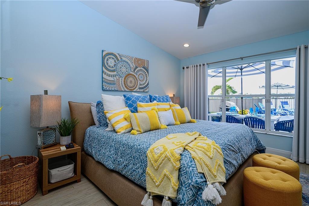 7311 Mill Pond Circle Naples, FL 34109 - Photo 22 of 42 a bedroom with two beds and a large window