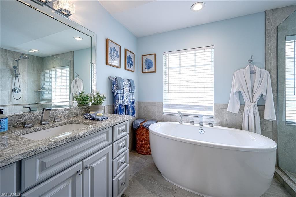 7311 Mill Pond Circle Naples, FL 34109 - Photo 25 of 42 a bath tub sitting next to a bathroom sink