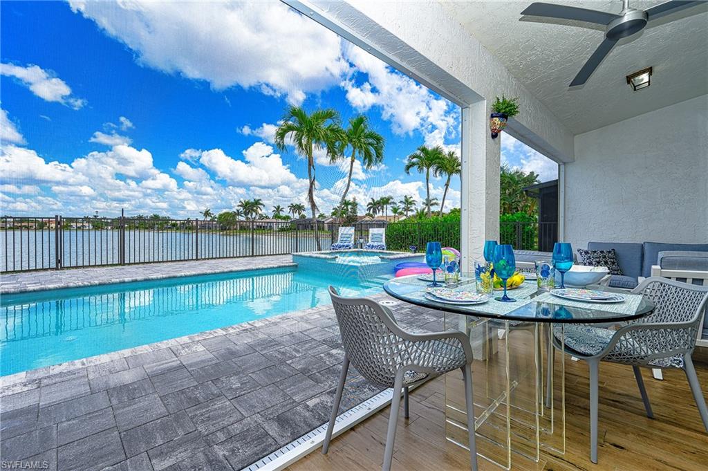 7311 Mill Pond Circle Naples, FL 34109 - Photo 32 of 42 a view of a chair and tables in the patio