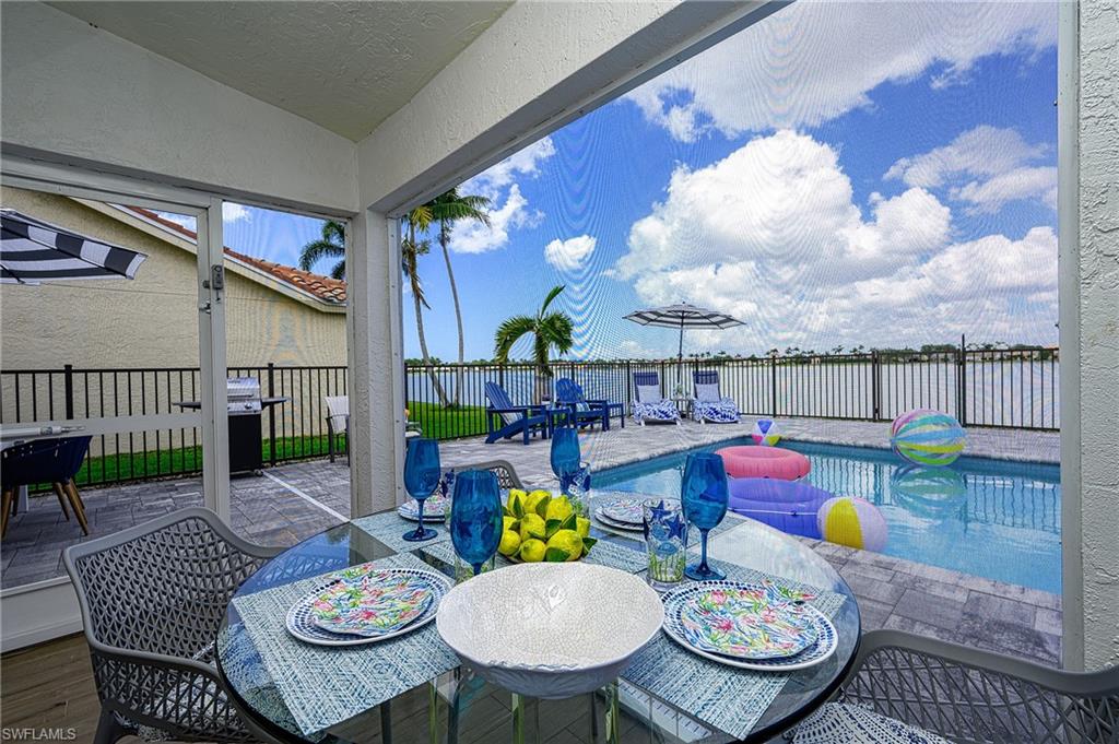 7311 Mill Pond Circle Naples, FL 34109 - Photo 34 of 42 a view of a dining table and chairs in the patio