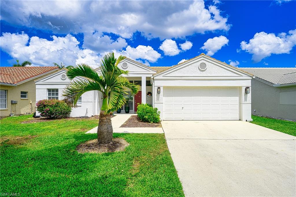 7311 Mill Pond Circle Naples, FL 34109 - Photo 39 of 42 a front view of a house with garden