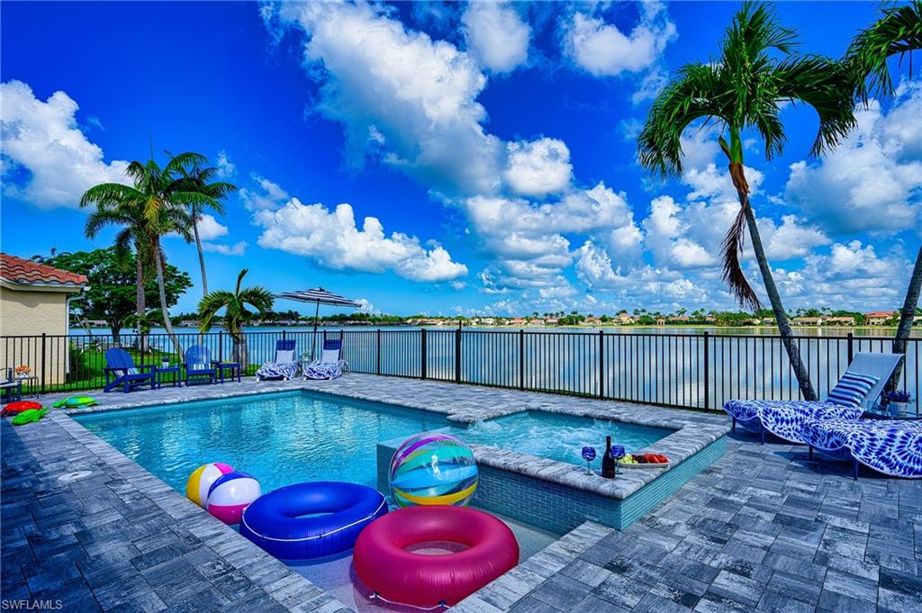 7311 Mill Pond Circle Naples, FL 34109 - Photo 4 of 42 a swimming pool with outdoor seating