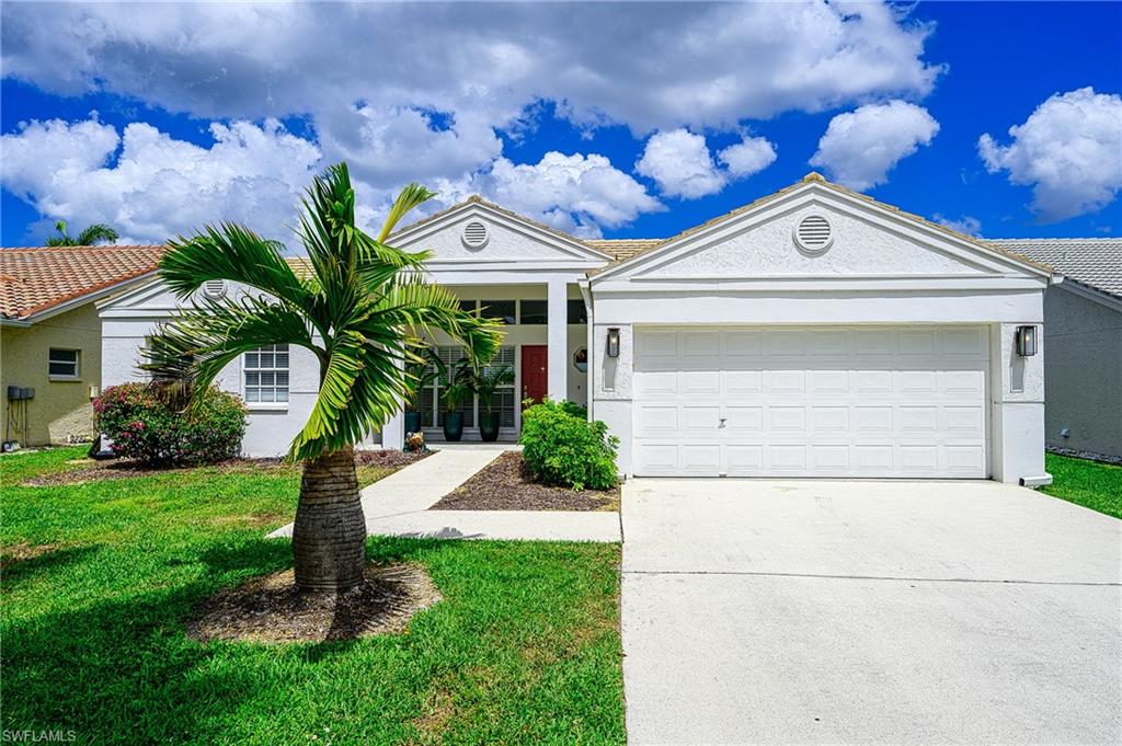 7311 Mill Pond Circle Naples, FL 34109 - Photo 41 of 42 a view of a house with a small yard and plants