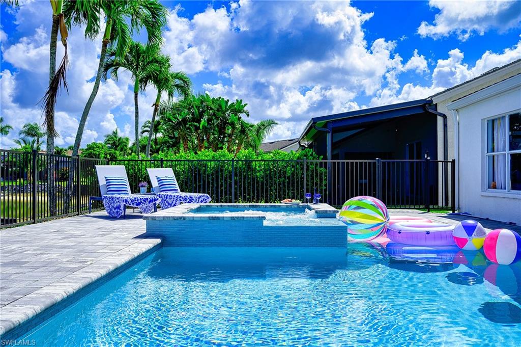 7311 Mill Pond Circle Naples, FL 34109 - Photo 7 of 42 a view of a swimming pool with a patio