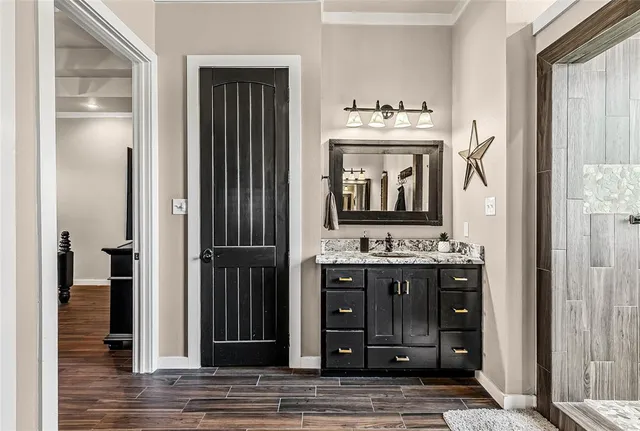 a bathroom with a sink a mirror and a shower