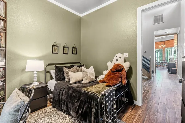 a view of a hallway with wooden floor and closet
