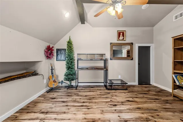 a en suite bathroom with a granite countertop sink and a mirror