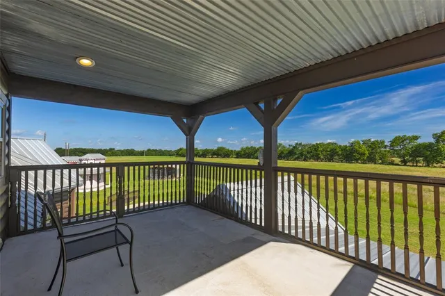 a living room with fireplace furniture and a large window