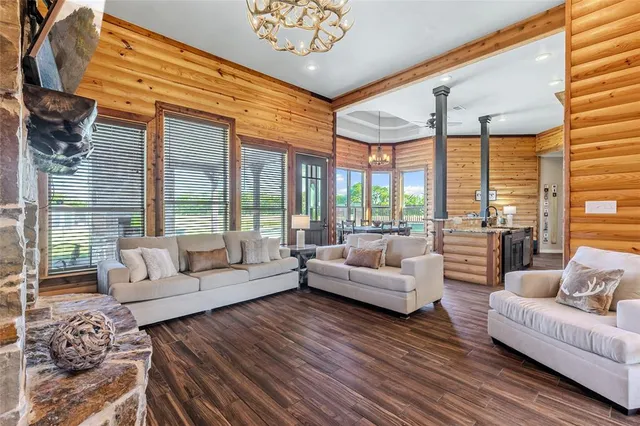 a living room with furniture and large windows
