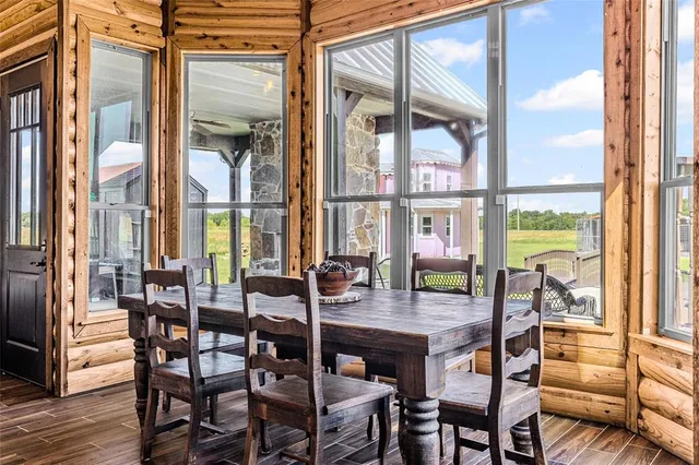 a dining room with furniture a chandelier and wooden floor