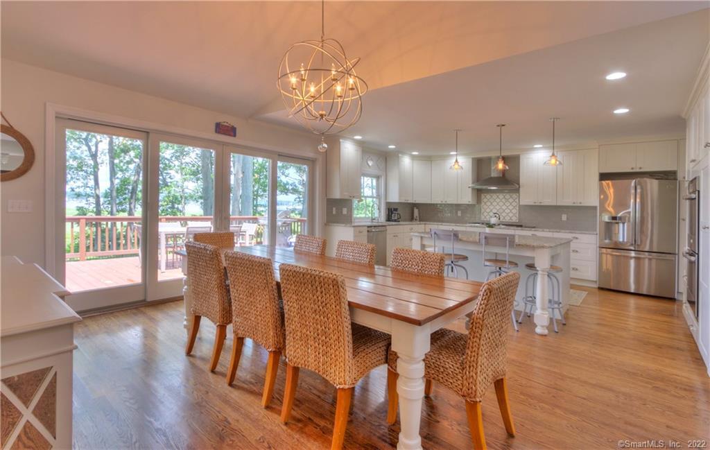 17 Fenway Road Branford, CT 06405 - Photo 1 of 1 a dining room with wooden floor a chandelier a wooden table and chairs