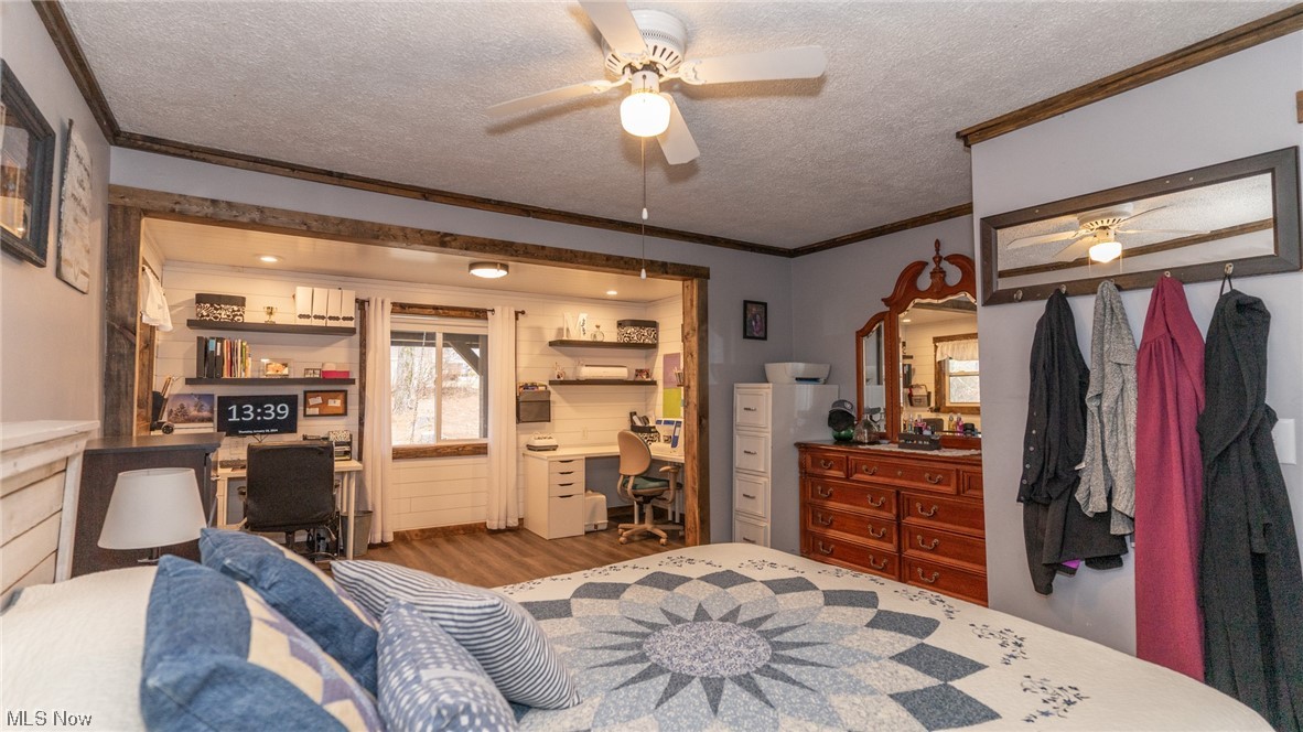 13962 Nickel Plate Road Logan, OH 43138 - Photo 20 of 46 Bedroom featuring crown molding, light wood-type flooring, a textured ceiling, and ceiling fan