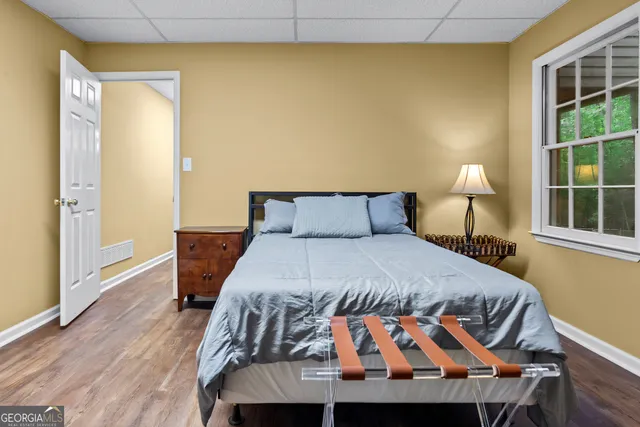 a view of a house with a yard and large trees
