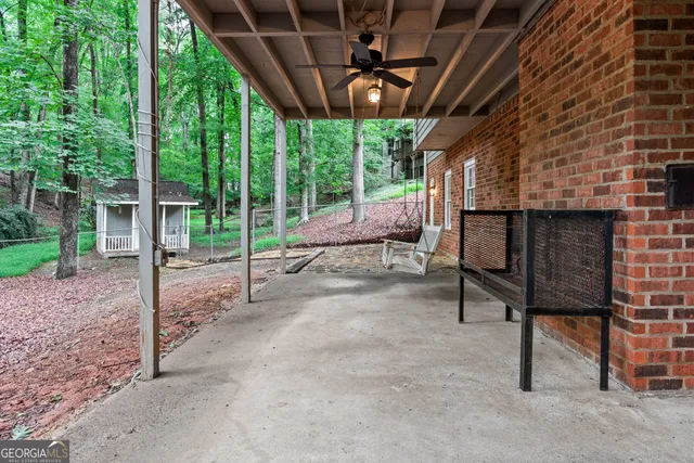 a front view of a house with yard patio and green space