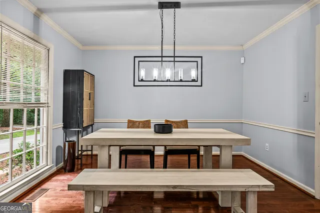 a view of a dining room with furniture window and wooden floor