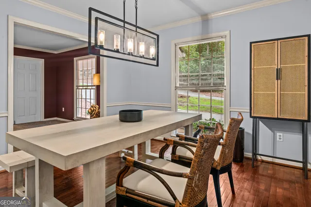 a view of a dining room with furniture and wooden floor