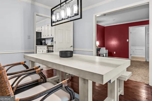 a kitchen with a table chairs sink and cabinets