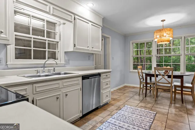 a kitchen with white cabinets and appliances
