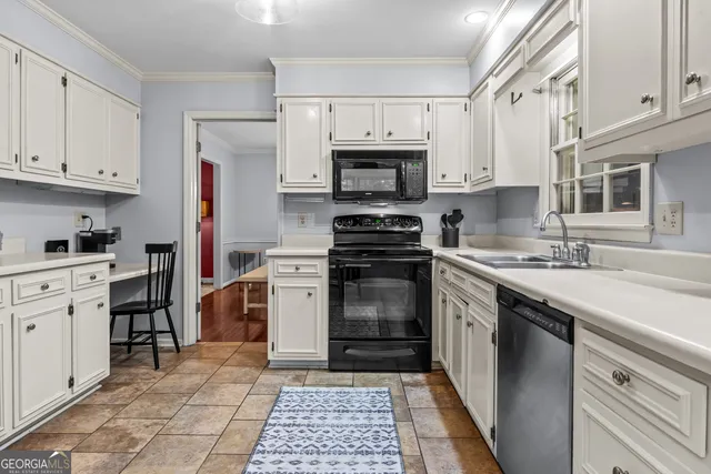 a kitchen with cabinets stainless steel appliances and a counter space