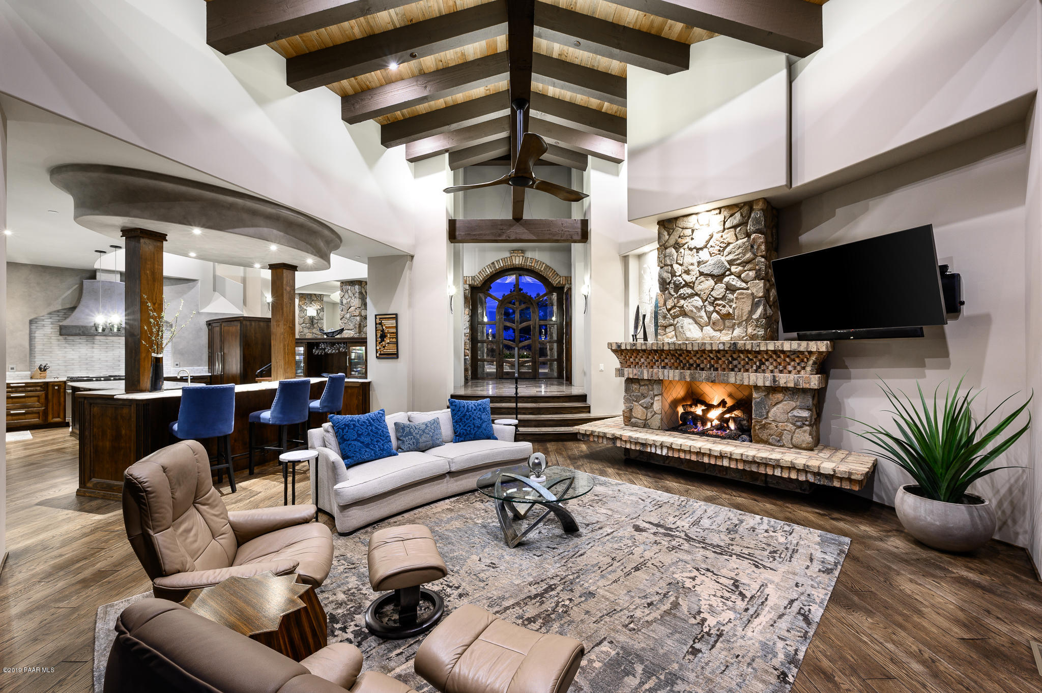 6785 West Almosta Ranch Road Prescott, AZ 86305 - Photo 16 of 81 a living room with furniture a flat screen tv and a fireplace