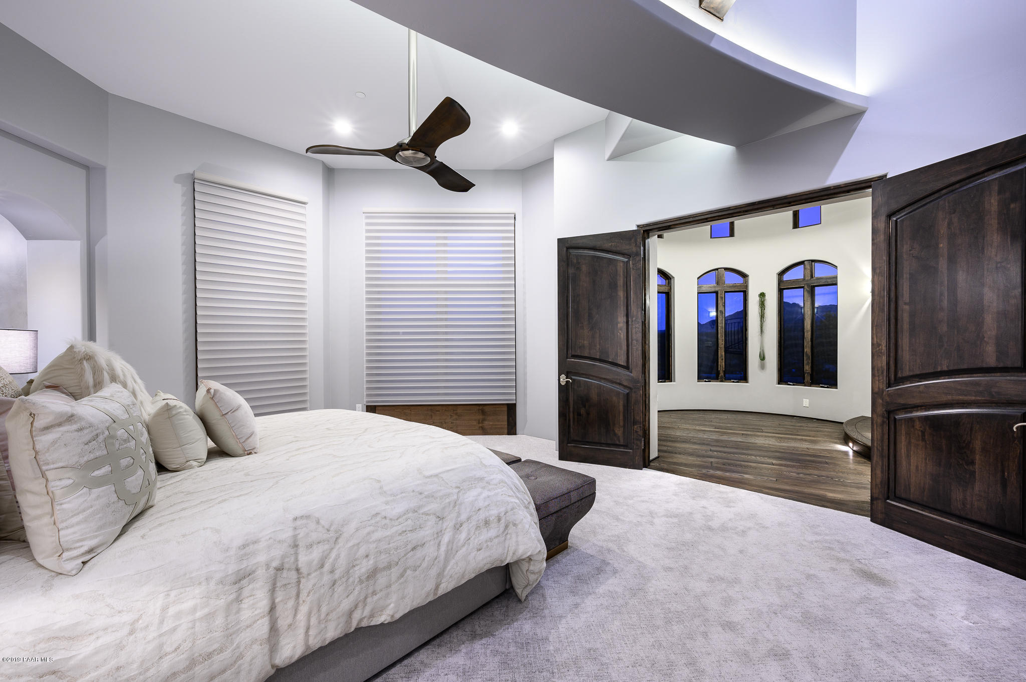 6785 West Almosta Ranch Road Prescott, AZ 86305 - Photo 36 of 81 a spacious bedroom with a large bed chandelier and a window