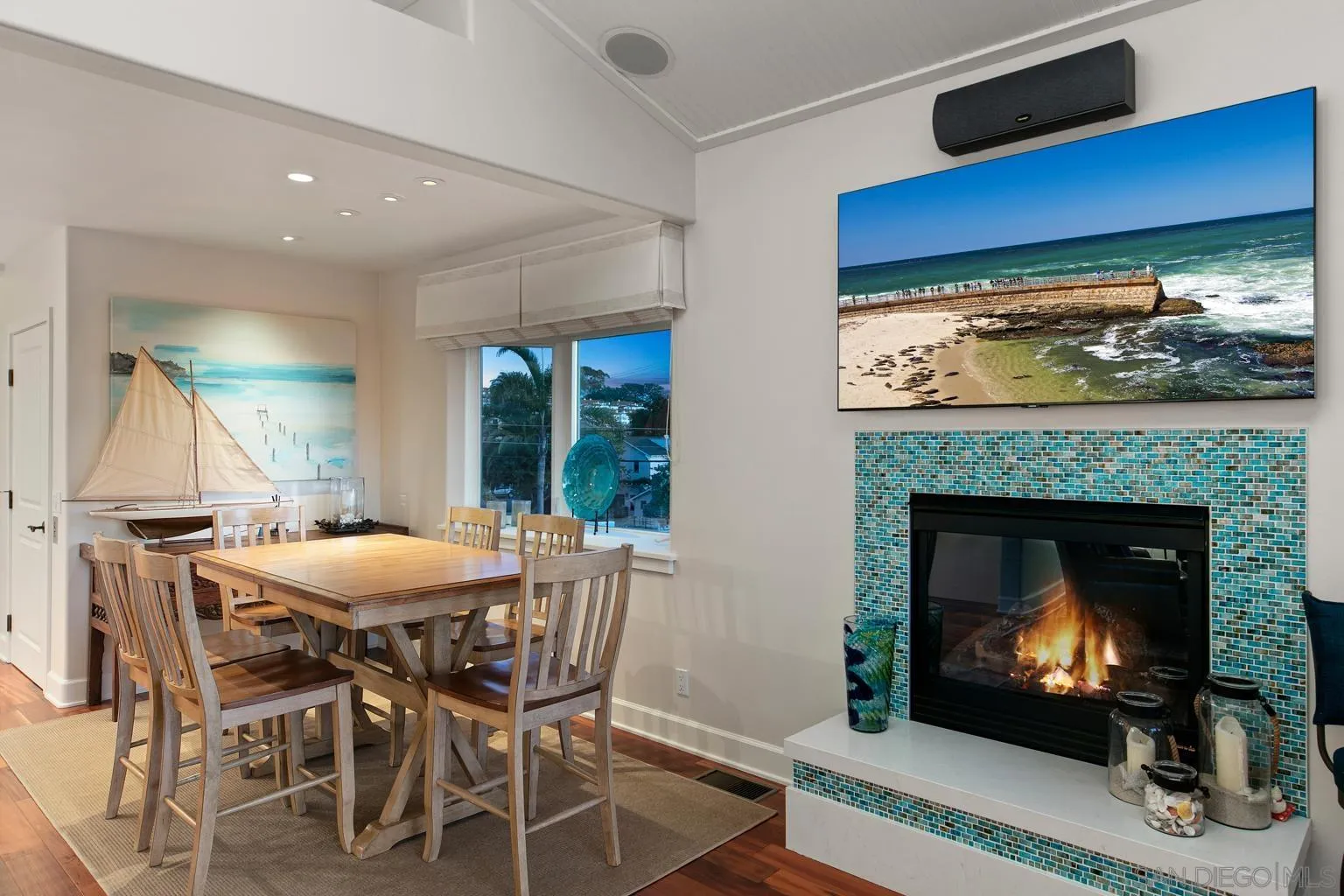 149 3rd Street Encinitas, CA 92024 - Photo 22 of 26 a dining room with a fireplace a rug and a fireplace
