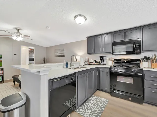 a kitchen with cabinets appliances and a sink