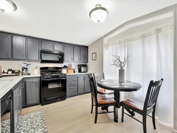 a kitchen with wooden cabinets and stove