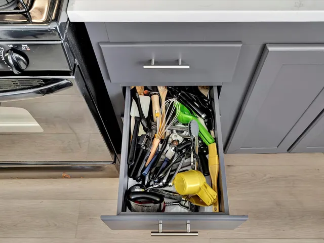 a kitchen with a refrigerator and a chair
