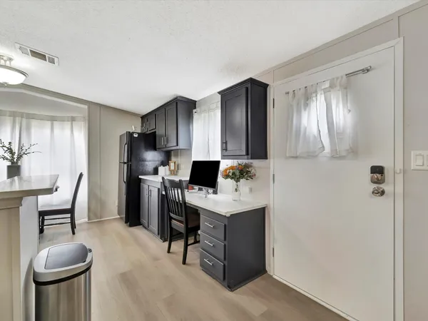 a spacious bedroom with a bed and a chandelier
