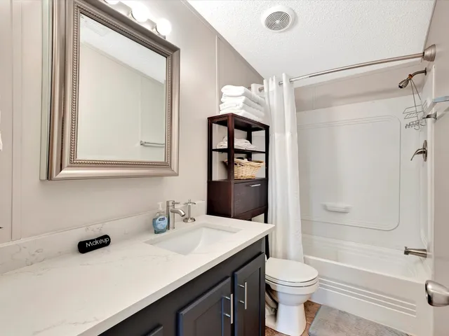 a bathroom with a tub and shower