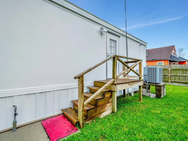a view of a house with a big yard and potted plants