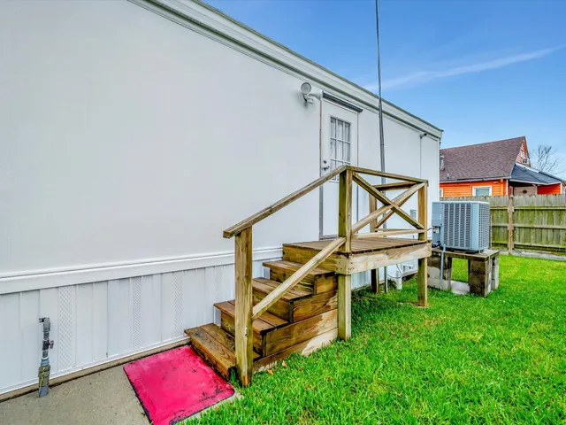 a view of a house with a big yard and potted plants