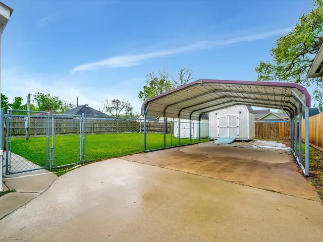 a backyard of a house with table and sofas