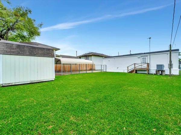 a view of house with backyard and seating area