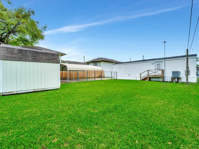 a view of house with backyard and seating area
