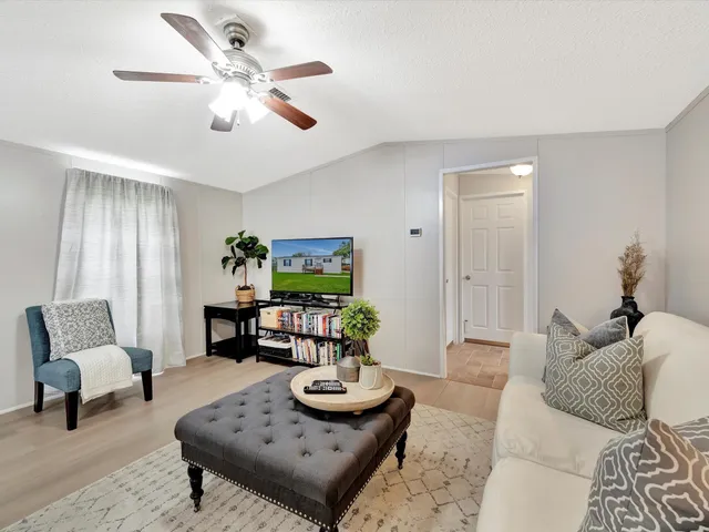a living room with furniture and book shelf