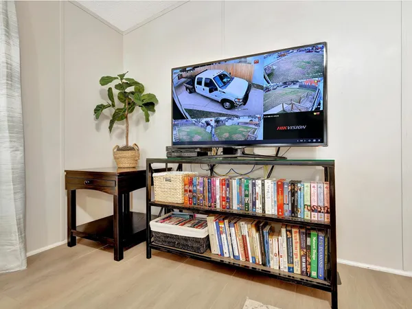 a living room with furniture a flat screen tv and a couch