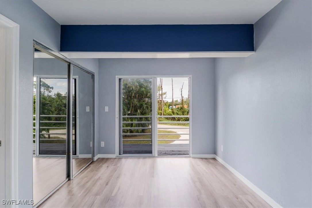 10925 Russell Road Bokeelia, FL 33922 - Photo 17 of 50 a view of an empty room with wooden floor and a window