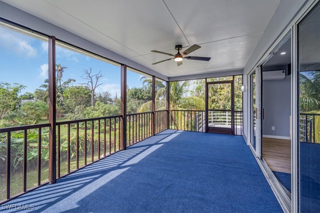 10925 Russell Road Bokeelia, FL 33922 - Photo 21 of 50 a view of a porch with wooden floor and outdoor space