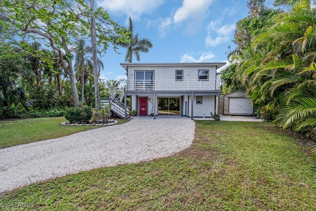 10925 Russell Road Bokeelia, FL 33922 - Photo 4 of 50 front view of a house with a yard
