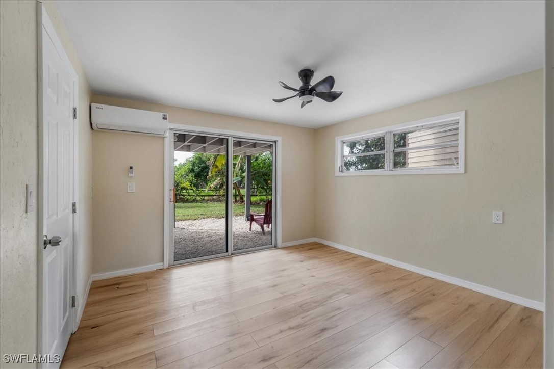 10925 Russell Road Bokeelia, FL 33922 - Photo 42 of 50 a view of an empty room with wooden floor and a window