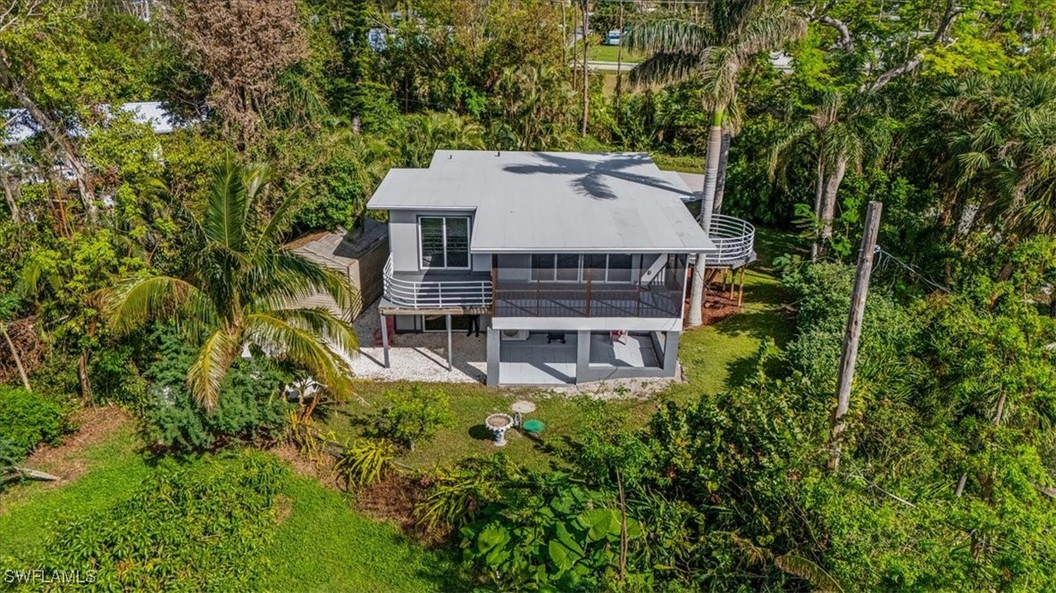10925 Russell Road Bokeelia, FL 33922 - Photo 46 of 50 an aerial view of a house with a yard table and chairs