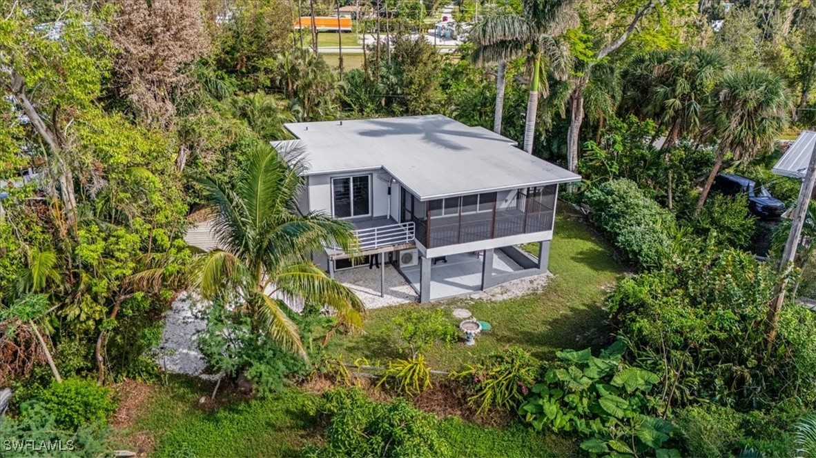 10925 Russell Road Bokeelia, FL 33922 - Photo 47 of 50 an aerial view of a house with a yard table and chairs