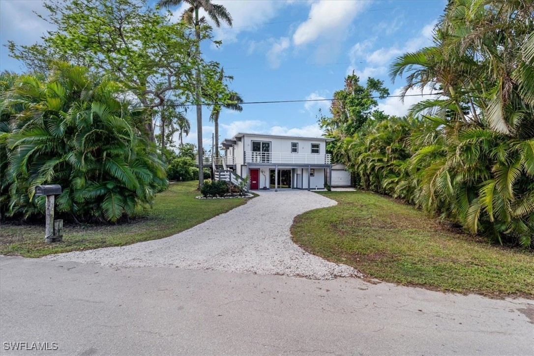 10925 Russell Road Bokeelia, FL 33922 - Photo 5 of 50 a view of house with outdoor space and trees